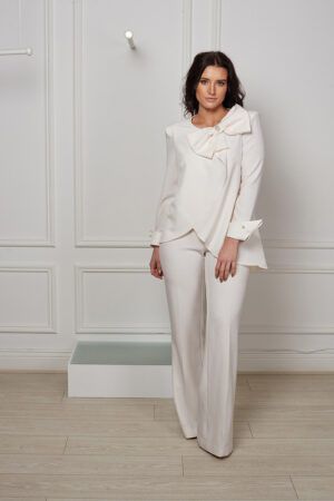 Ivory flowing blouse with pearl bow and cuff and wide leg trousers