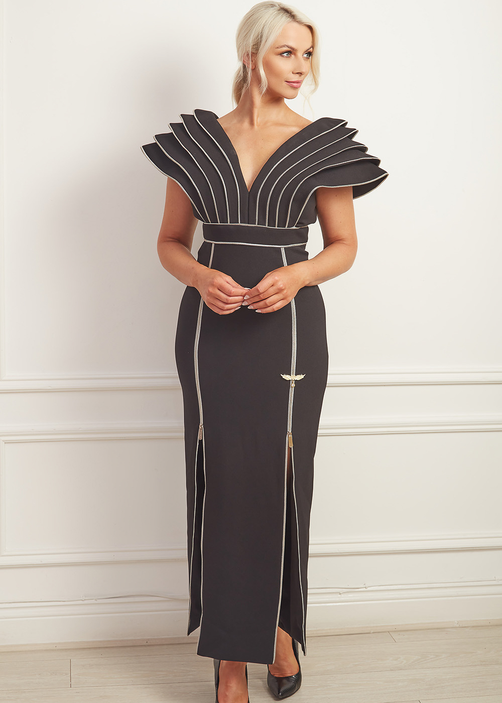 Black column gown with dramatic shoulders and silver zip detailing